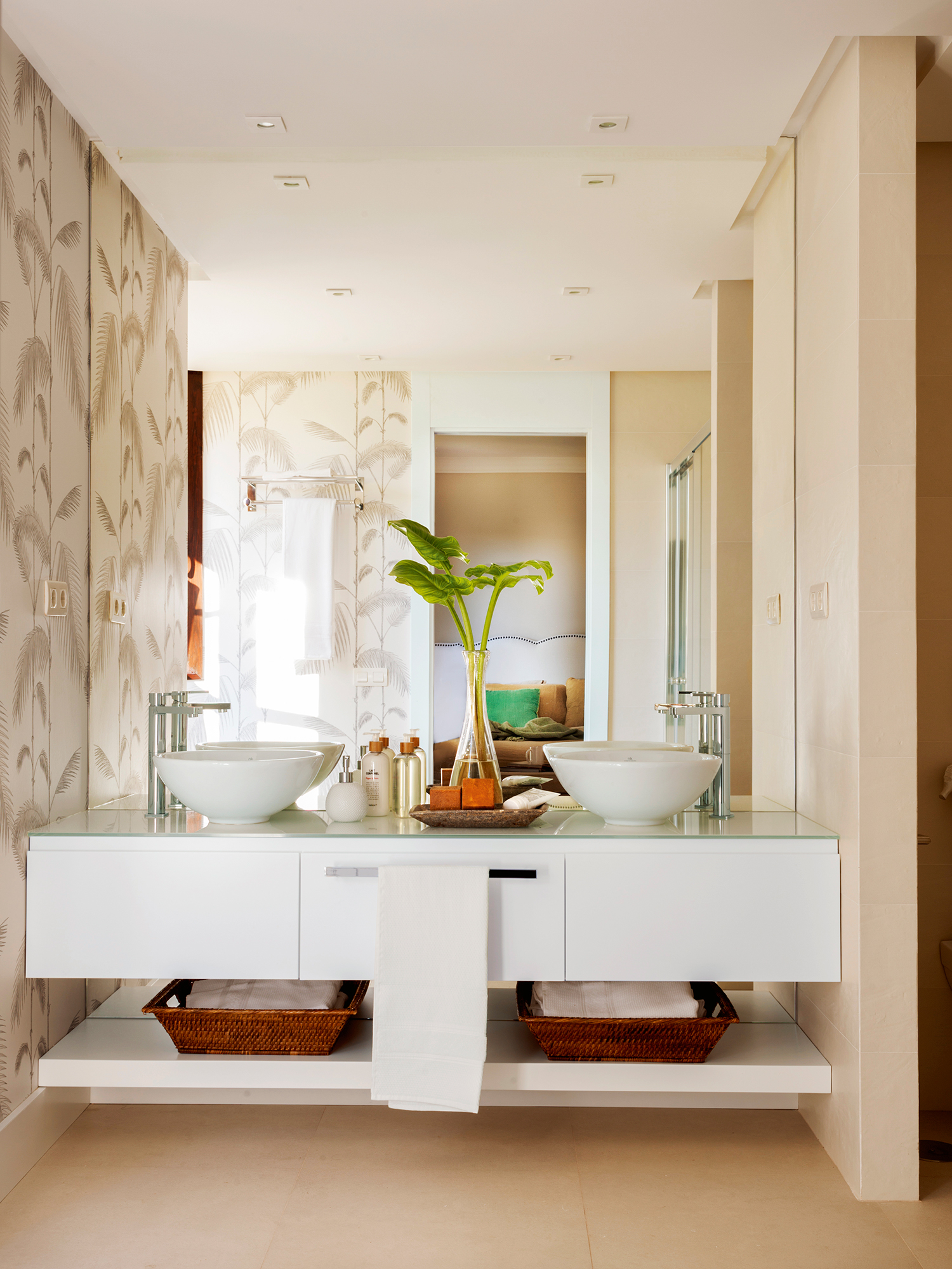 Baño moderno con papel pintado de motivos vegetales. 
